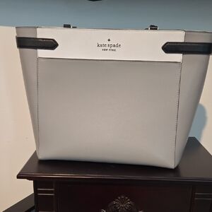 kate spade light gray tote with silver logo plate